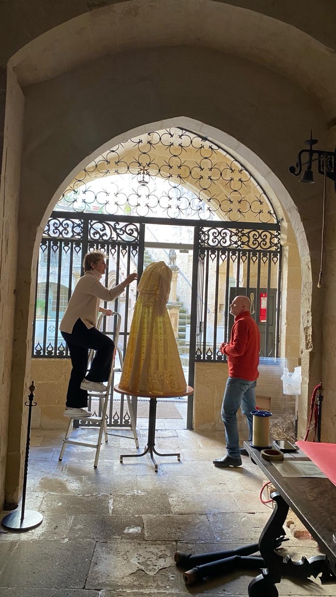 Caroline mounting the unique two piece handmade lace ensemble from Casa Rocca Piccola collection with artist Louis Zammit, maker of bespoke mannequin for Curious Beauty exhibtion